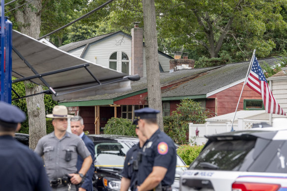 Police are seen outside the home of Rex Heuermann, the suspect in the Gilgo Beach murders, in Massapequa Park, New York.