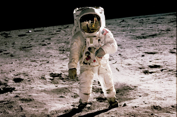 Buzz Aldrin walks on the moon in 1969. Fellow astronaut Neil Armstrong, the first to set foot on the moon, is seen reflected in Aldrin’s visor.