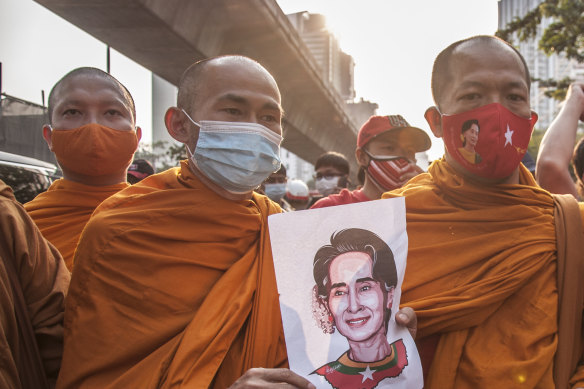 Thai monks hold a portrait of Aung San Suu Kyi during a demonstration outside the Burmese embassy in Bangkok.