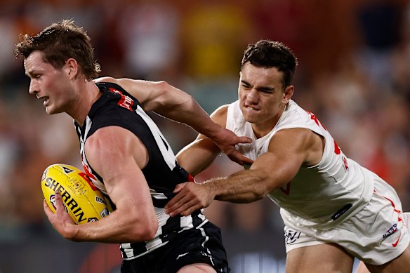 Ned Long of the Magpies is tackled by Caiden Cleary of the Swans.