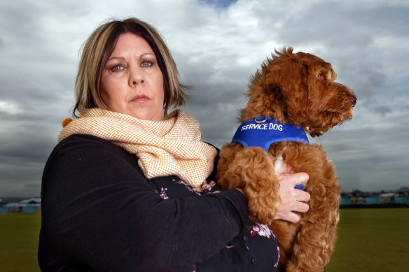 Kathy Pritchard, with husband Mike's therapy dog,  says she is "tired of the fight".