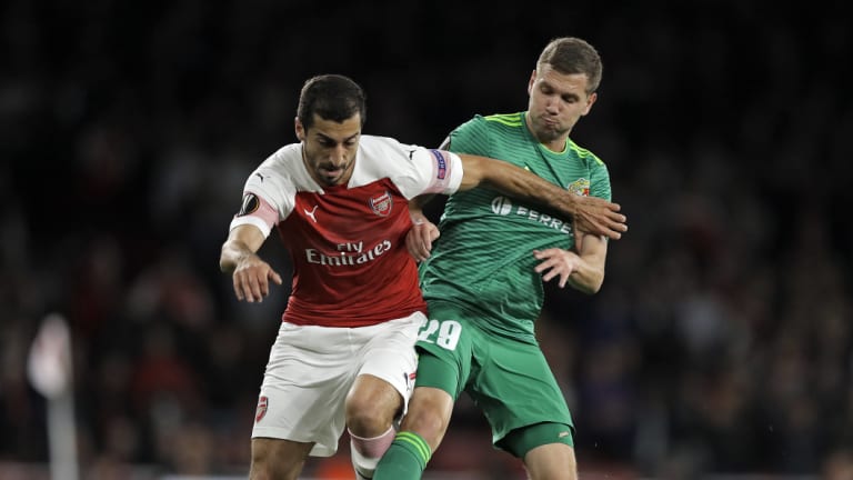 Staying put: Henrikh Mkhitaryan (left), in Europa League action earlier this season, will miss this week's trip.