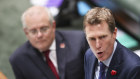 The Prime Minister is standing behind his Attorney-General.