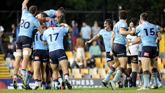 The Waratahs celebrate at full-time after knocking off the Crusaders at Leichhardt Oval.
