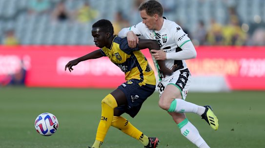 Central Coast’s Garang Kuol holds off Neil Kilkenny of Western United on Saturday in Gosford.