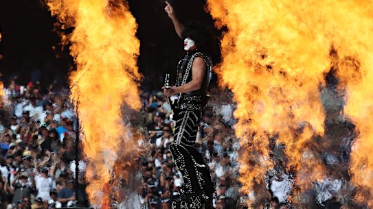 Paul Stanley is dwarfed by a wall of flames as KISS perform at the AFL grand final.