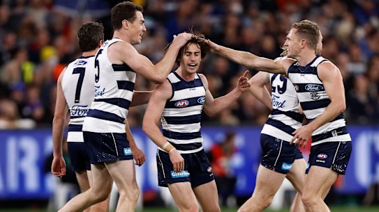 Gryan Miers and the Cats celebrate a goal.
