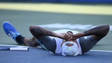 Nick Kyrgios lies on court after his victory in the final.