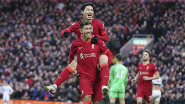 Liverpool’s Takumi Minamino (top) celebrates with Roberto Firmino after scoring against Brentford.