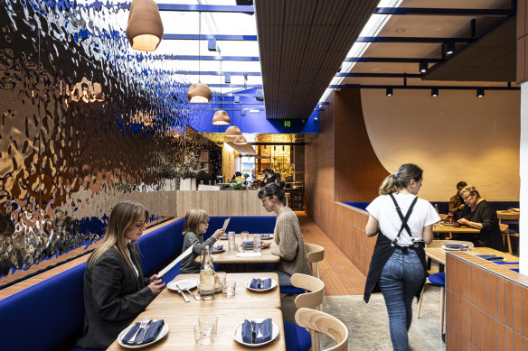 Henrietta’s rear dining room features beaten silver and blue accents.