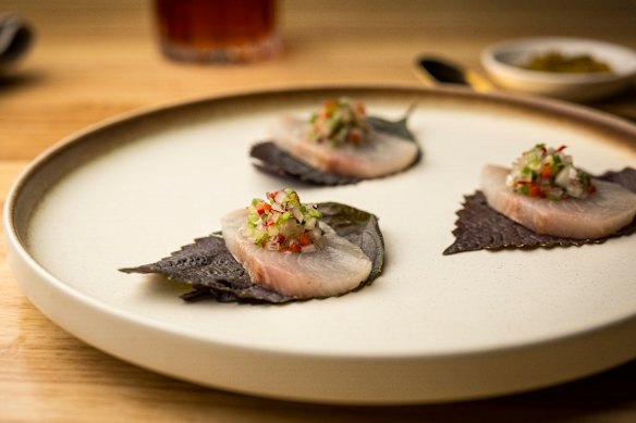 Raw kingfish draped across a shiso leaf and topped with pineapple salsa and a tamarind-heavy granita that mimics assam laksa. 