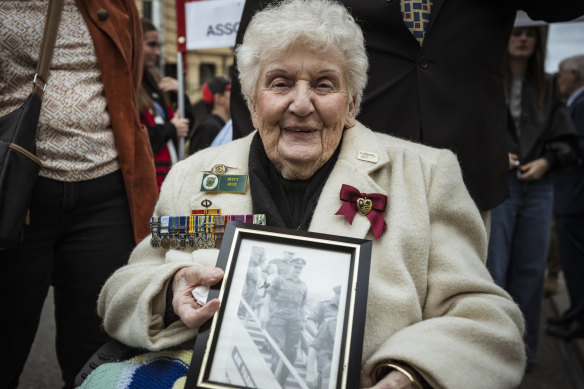 Betty Quee, 87, held a picture of her husband Brian Quee as she joined her first-ever Anzac Day procession in Melbourne.