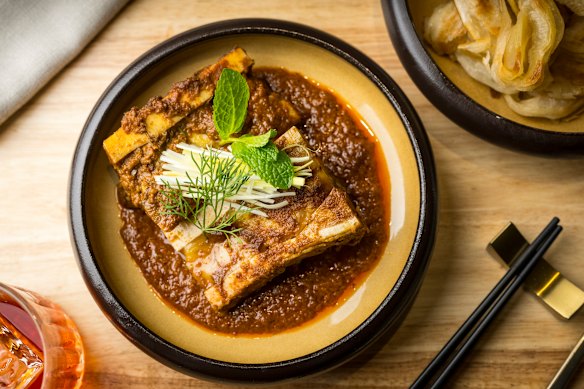 Rendang with stretchy roti, accompanied by two fat bones full of marrow.