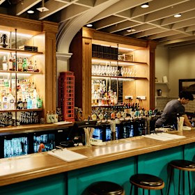 The old Little Big House has been given a very British vibe to become The Rose &amp; Crown, with a white-and-teal paint job, walls decorated with plates and old-school paintings.