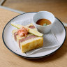 Diners queuing out the door for sandos at this Japanese vinyl cafe