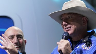Not quite the right stuff: Mark Bezos, left, listens as his brother Jeff Bezos, speaks.