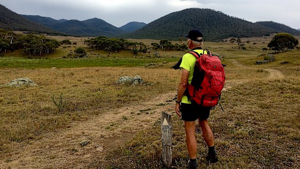 John Evans looks towards the distant horizon and his three favourite peaks in Namadgi National Park – Mt Kelly, Mt Burbidge and Mt Namadgi.