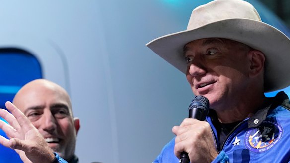 Not quite the right stuff: Mark Bezos, left, listens as his brother Jeff Bezos, speaks.