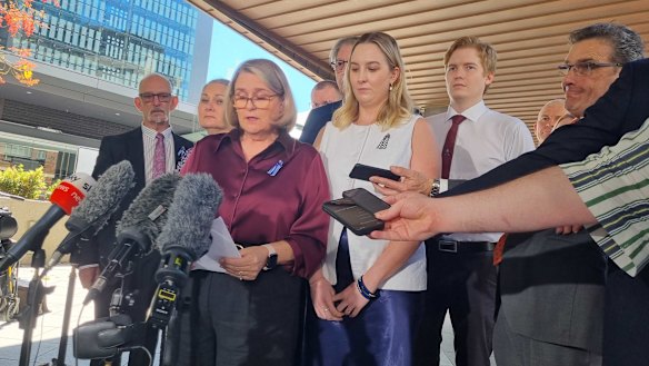 The families of constables Matt Arnold and Rachel McCrow outside the Coroners Court in Brisbane.
