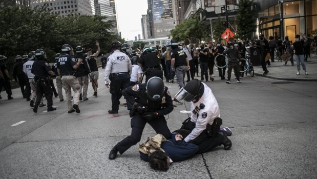 Police arresting protesters refusing to get off the streets during an imposed curfew in New York. 