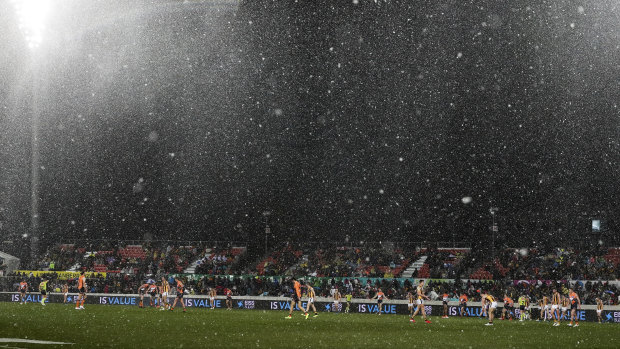 It's believed to be the first time snow has fallen during an AFL game. 