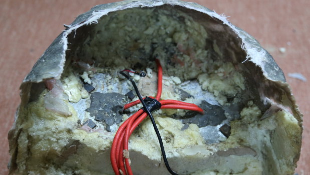 In this photograph provided by Conflict Armament Research, an independent London-based group that researches battlefield weaponry, an explosive disguised as a rock is on display in Yemen. 