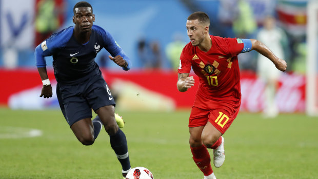 France's Paul Pogba challenges for the ball with Belgium's Eden Hazard.