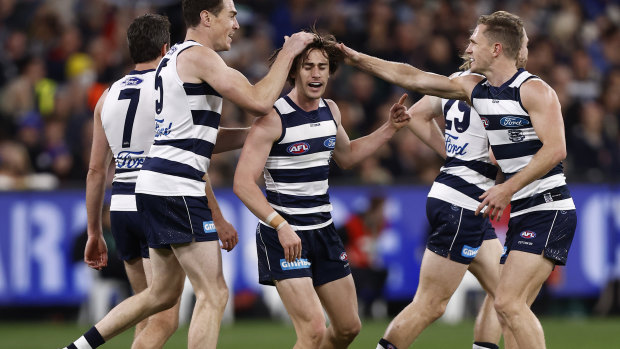 Gryan Miers and the Cats celebrate a goal.