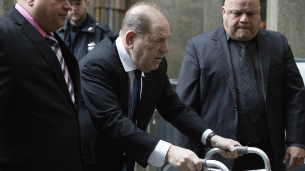 Harvey Weinstein, centre, arrives for a court hearing on Wednesday in New York.