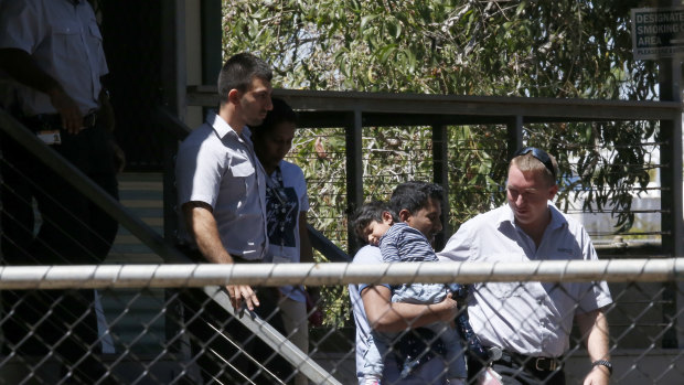 The family is removed from a secure apartment section at the Mercure Hotel in Darwin on Friday.