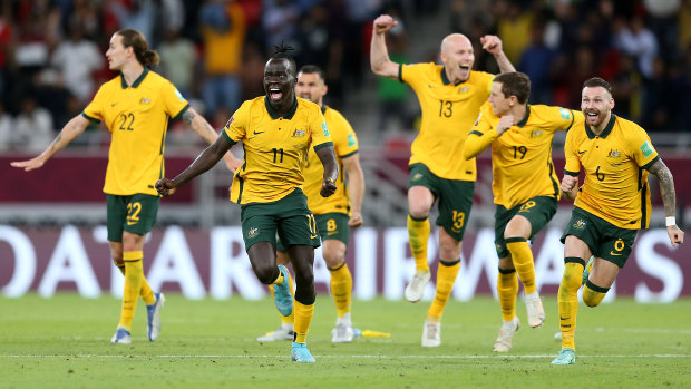 The Socceroos erupt with joy.