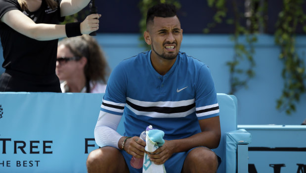 Nick Kyrgios with a water bottle during a change of ends.