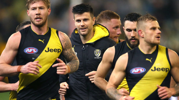 Trent Cotchin runs off the ground with teammates at half-time in the match on Friday against Collingwood.