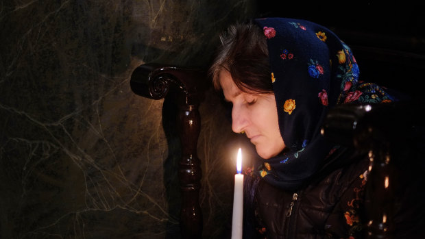 A worshipper holds a candle during an Easter service at the Patriarchal Cathedral of St George in Istanbul.