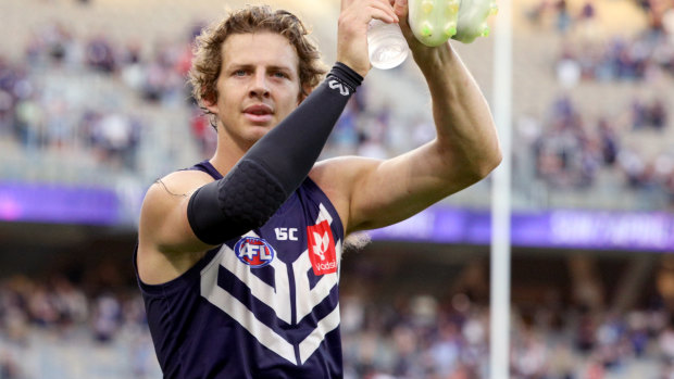 Nat Fyfe salutes the crowd at Optus Stadium after the Dockers unveiled a new game style against the Roos.