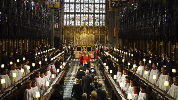 King Charles III and members of the royal family follow the coffin of Queen Elizabeth II as it is carried into St George’s Chapel for her committal service.