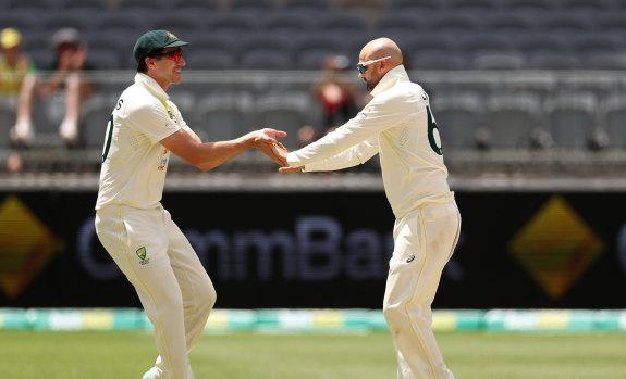 Nathan Lyon and Pat Cummins celebrate his breakthrough wickets.