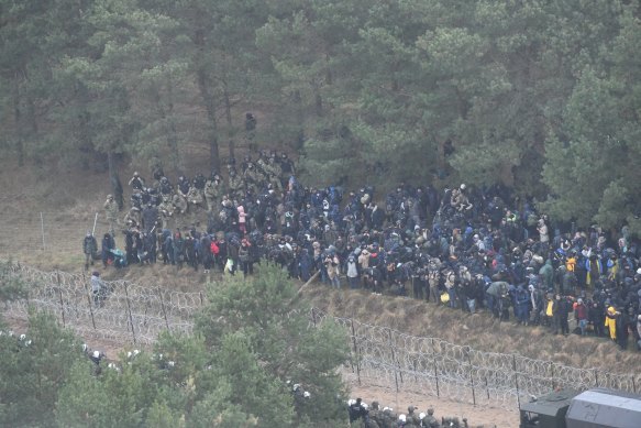 Polish border army units stand guard as migrants gather near the Kuznica border crossing on the Belarusian-Polish border.