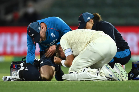 Joe Root doubles over in pain after being hit by a delivery from Mitchell Starc late on Sunday.