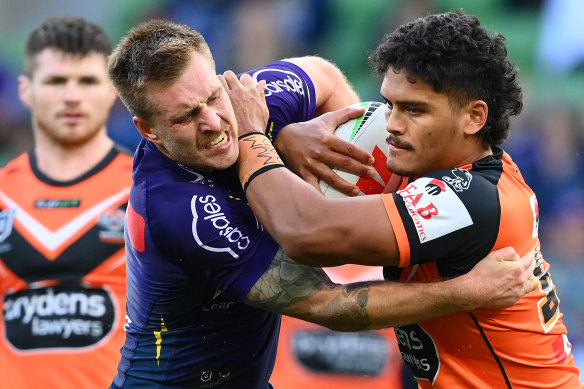 Shawn Blore is tackled by Cameron Munster.