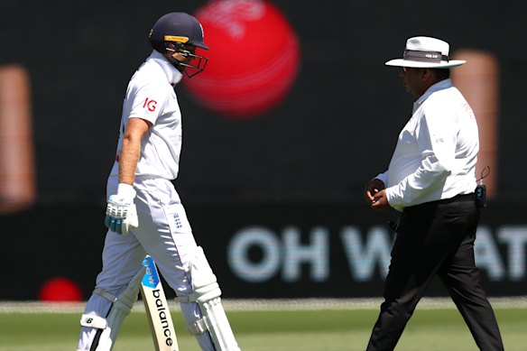 Joe Root of England walks off the ground after being dismissed by Pat Cummins of Australia for 39.