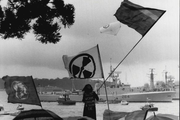 Anti-nuclear demonstrators protest at Lady Macquarie’s Chair as visiting warships arrive at Garden Island in Sydney Harbour, 1986.