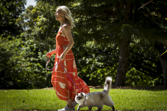 Penelope Dudgeon, owner of fashion brand Lady Fox, walks her cats to post customer orders.