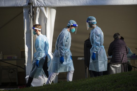 Health officials at a pop-up testing site outside the towers on Sunday.