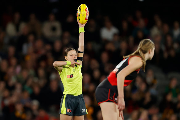 Emma Stark umpires during Saturday night’s inaugural AFLW clash between Essendon and Hawthorn.
