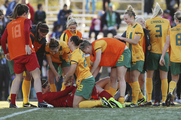 Australian teammates congratulate goalkeeper Brianna Davey after success in a penalty shootout.