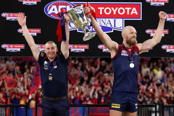 Melbourne coach Simon Goodwin and captain Max Gawn lift the premiership cup last year.