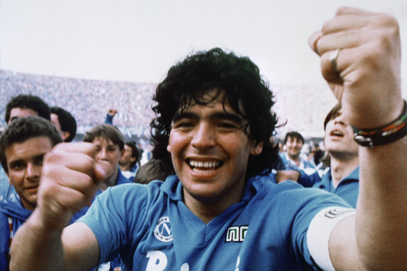Maradona cheers after the Napoli team clinched their first Serie A title in 1987.