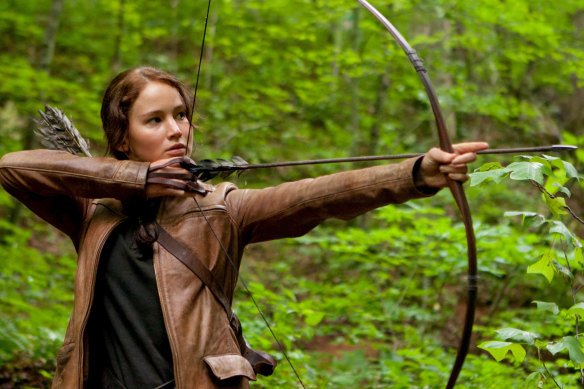 Jennifer Lawrence takes aim as Katniss Everdeen in the film The Hunger Games.