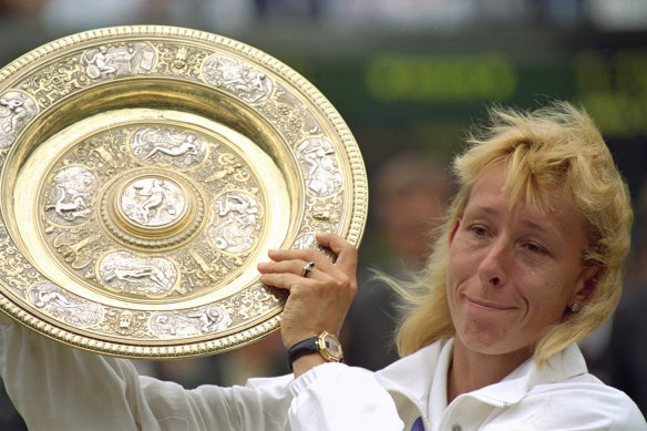 Navratilova fights back tears as she poses with her record ninth Wimbledon ladies singles championship trophy in 1990.